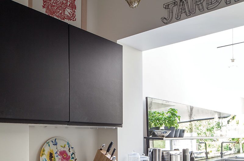 Industrial-style kitchen with black cabinetry and concrete worktop