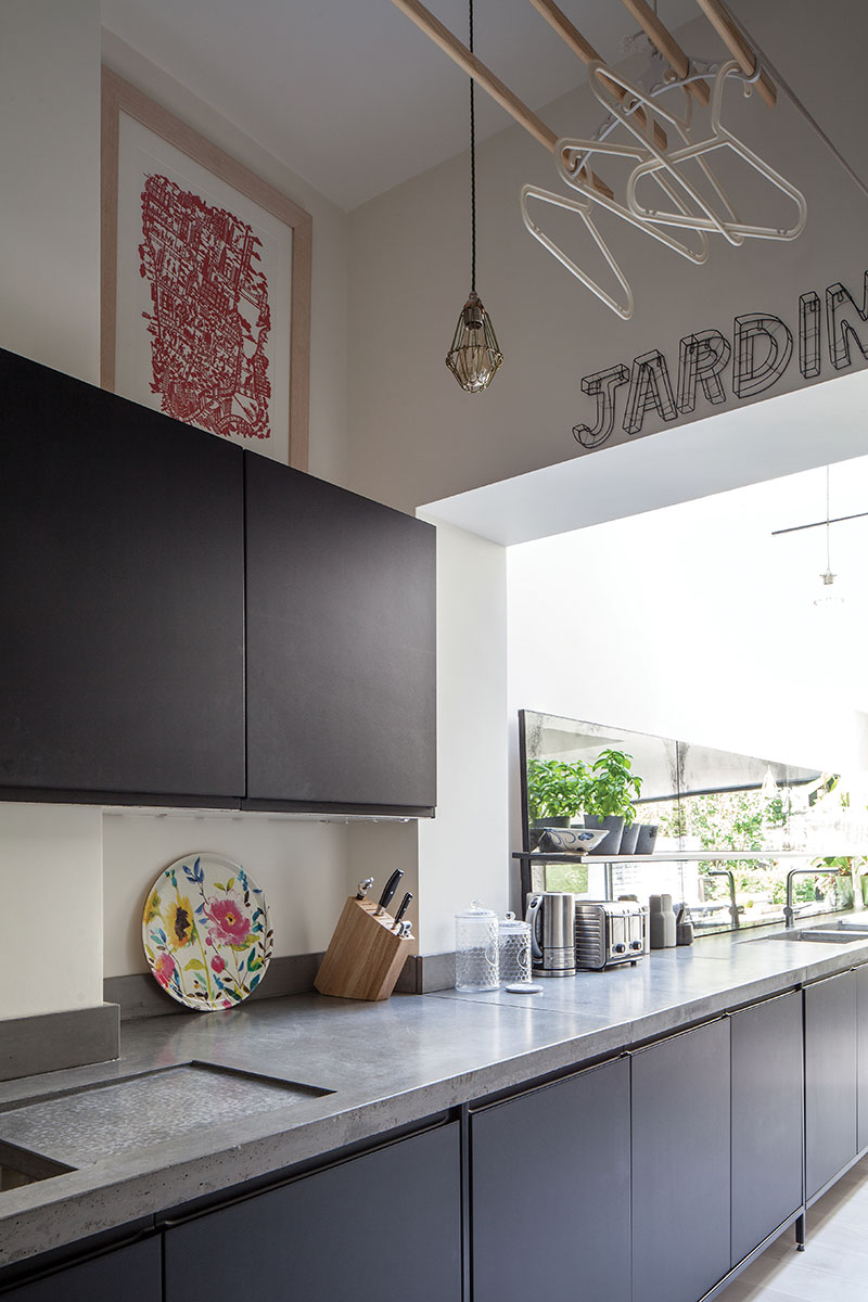Industrial black cabinetry with concrete worktop