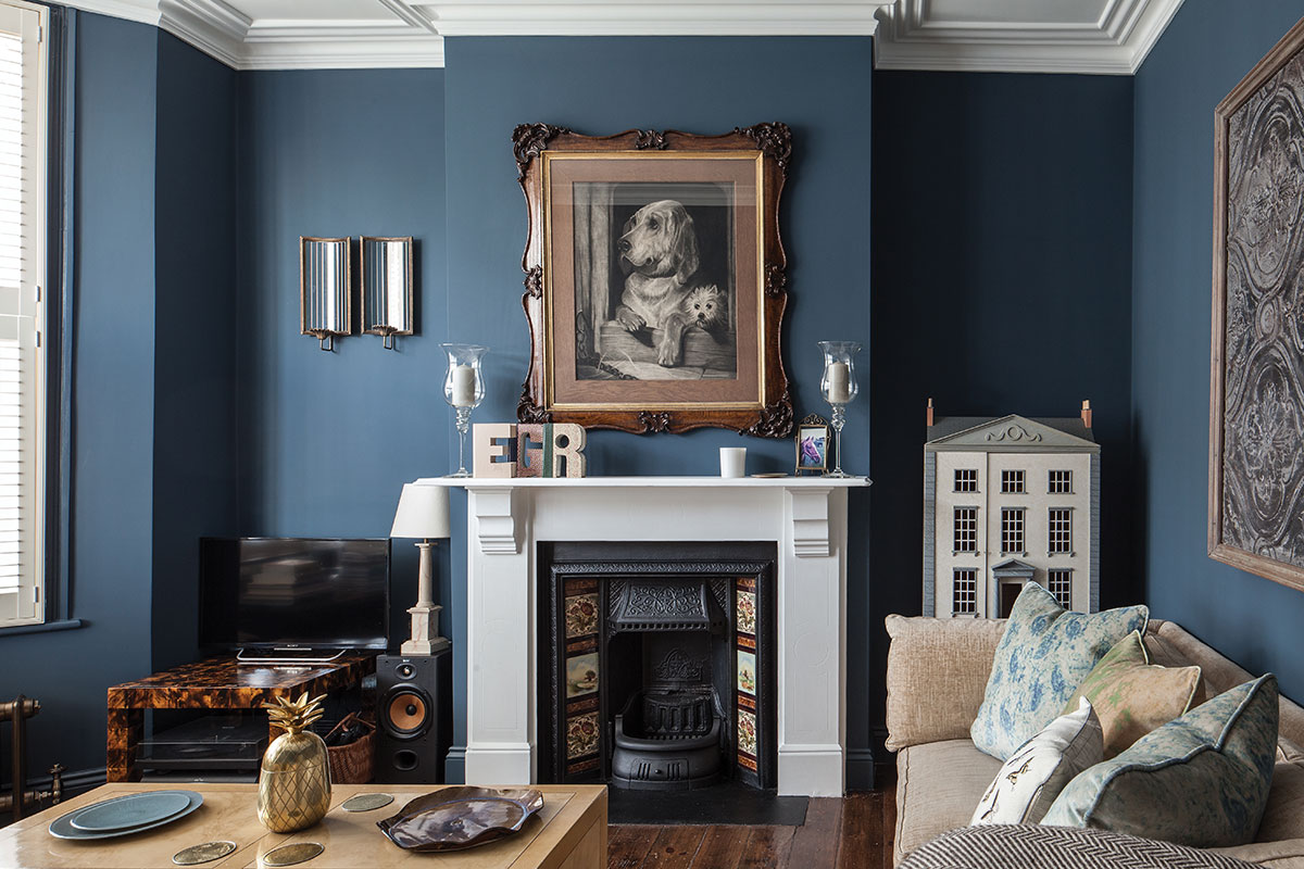 Dark blue wall in sitting room with dog portrait