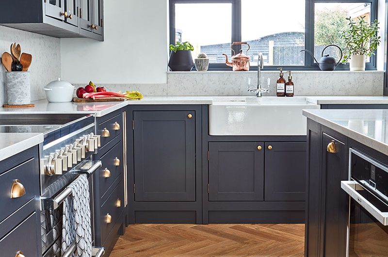 the country-style kitchen has been painted in navy blue
