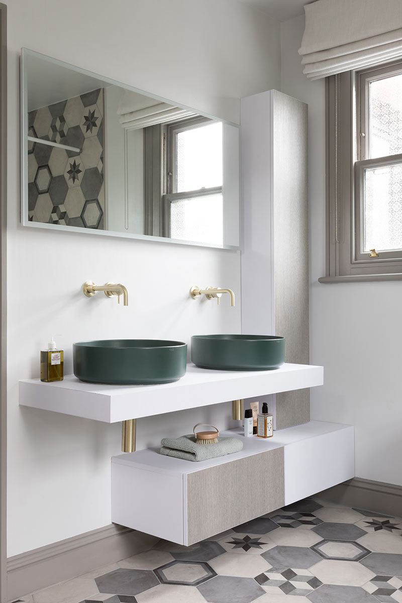 Double vanity with green basins and large mirror