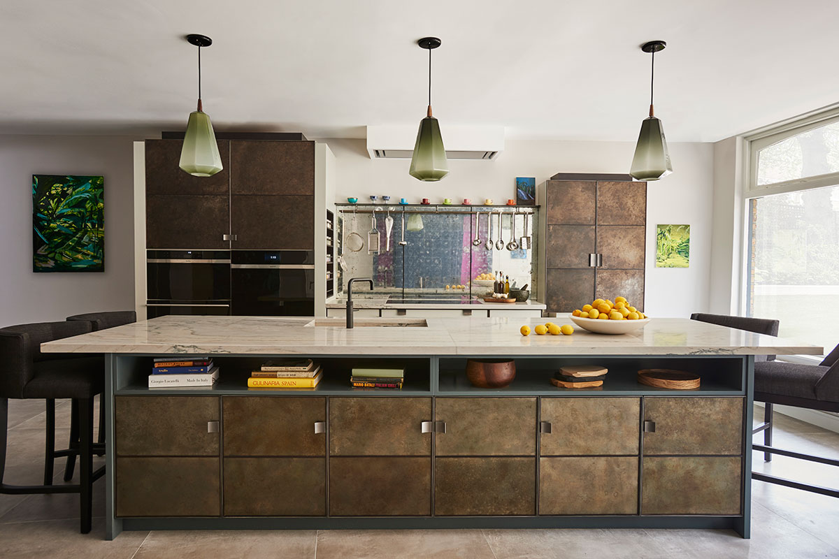 Large kitchen island with metallic doors by Ledbury Studio