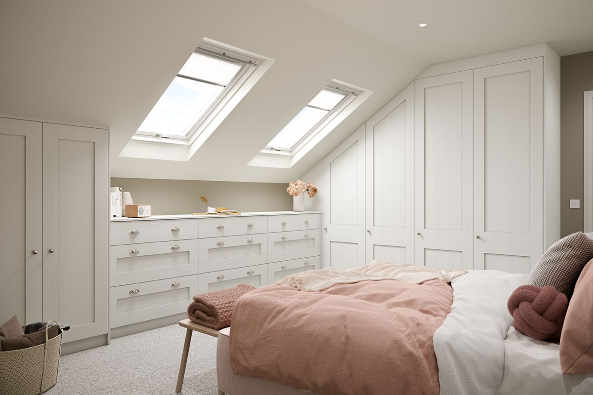 Bedroom under eaves with fitted storage under the eaves and on a tall wall