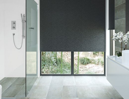 Bright wetroom with large grey blinds and wood effect floor illustrating a feature on how to create a wetroom bathroom