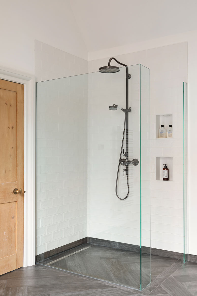 A bathroom design with walk-in shower