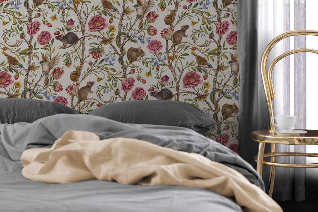 space with neutral bedding and floral patterned wallpaper
