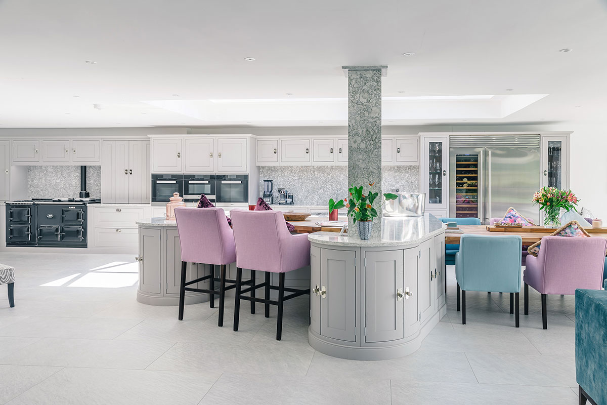 More traditional grey kitchen with pillar and colourful seats