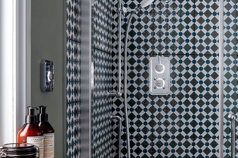 Enclosure with patterned wall tiles and digital shower 
