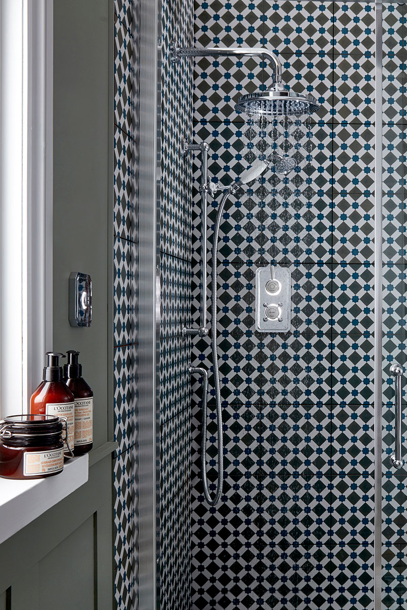 Enclosure with patterned wall tiles and digital shower 