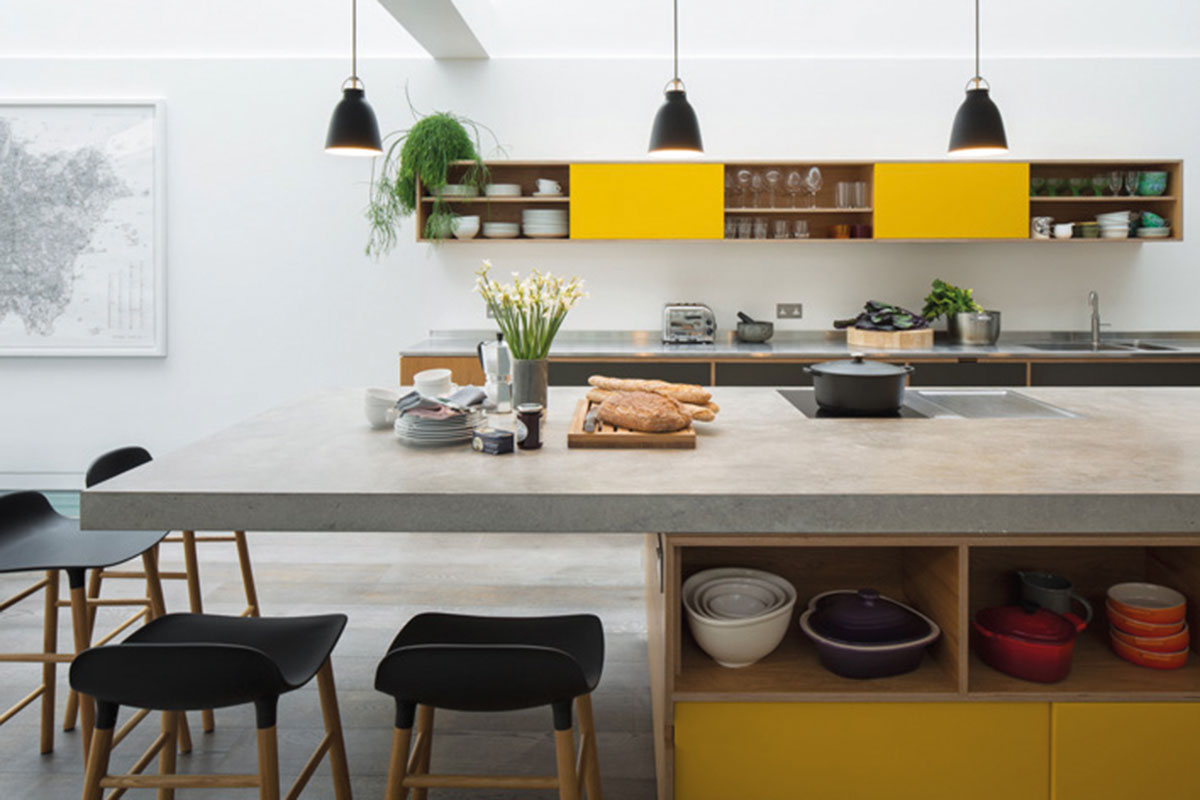 A kitchen with a concrete worktop