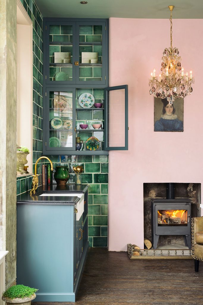 Devol kitchen with green tiles and pink wall
