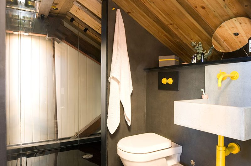 black and yellow bathroom with roof glazing