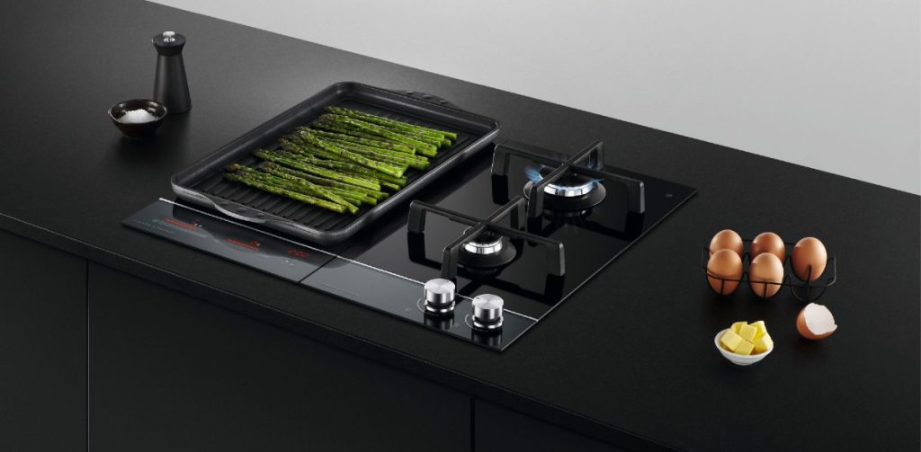 a Fisher & Paykel induction hob with asparagus, eggs and butter around it