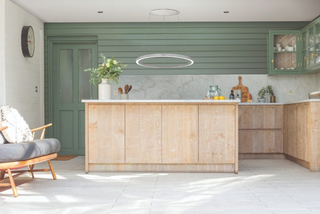 a statement ring in a green and wooden kitchen