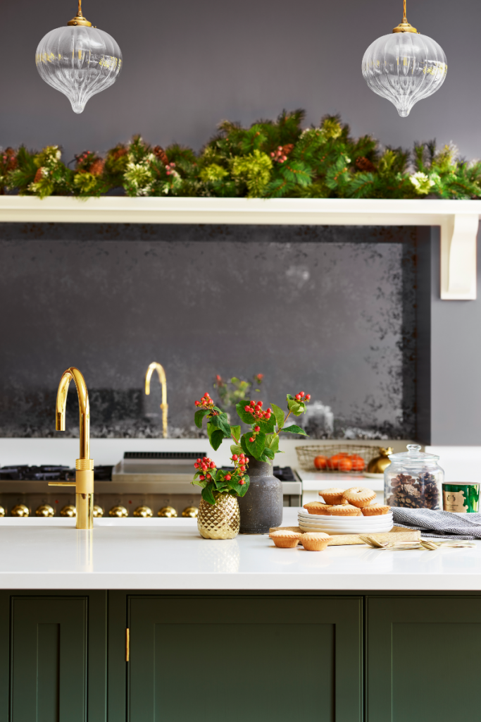 Classic Christmas decor in green kitchen with holly berries and foliage