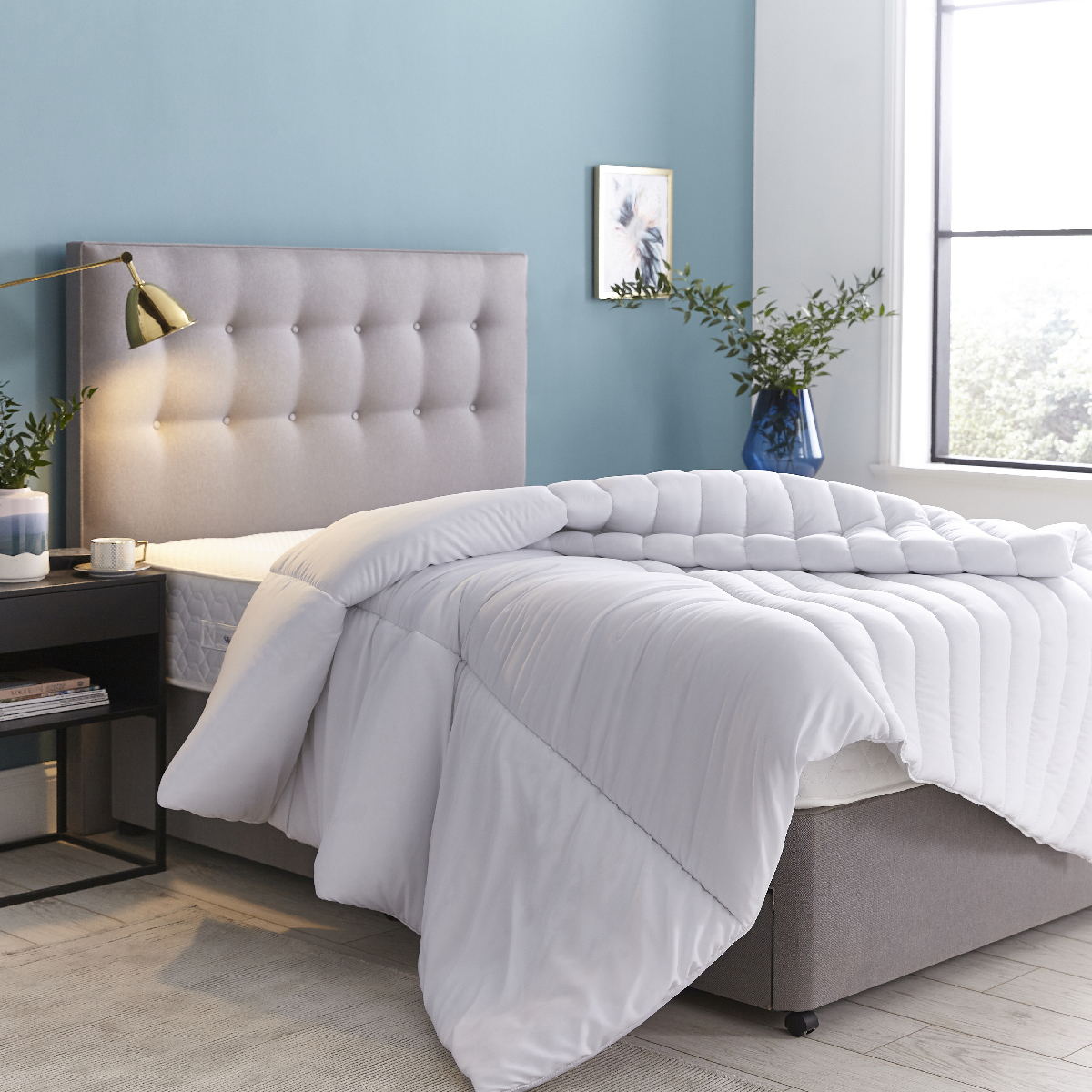 How to sleep better? Find the right duvet. Blue bedroom with grey bed and big duvet