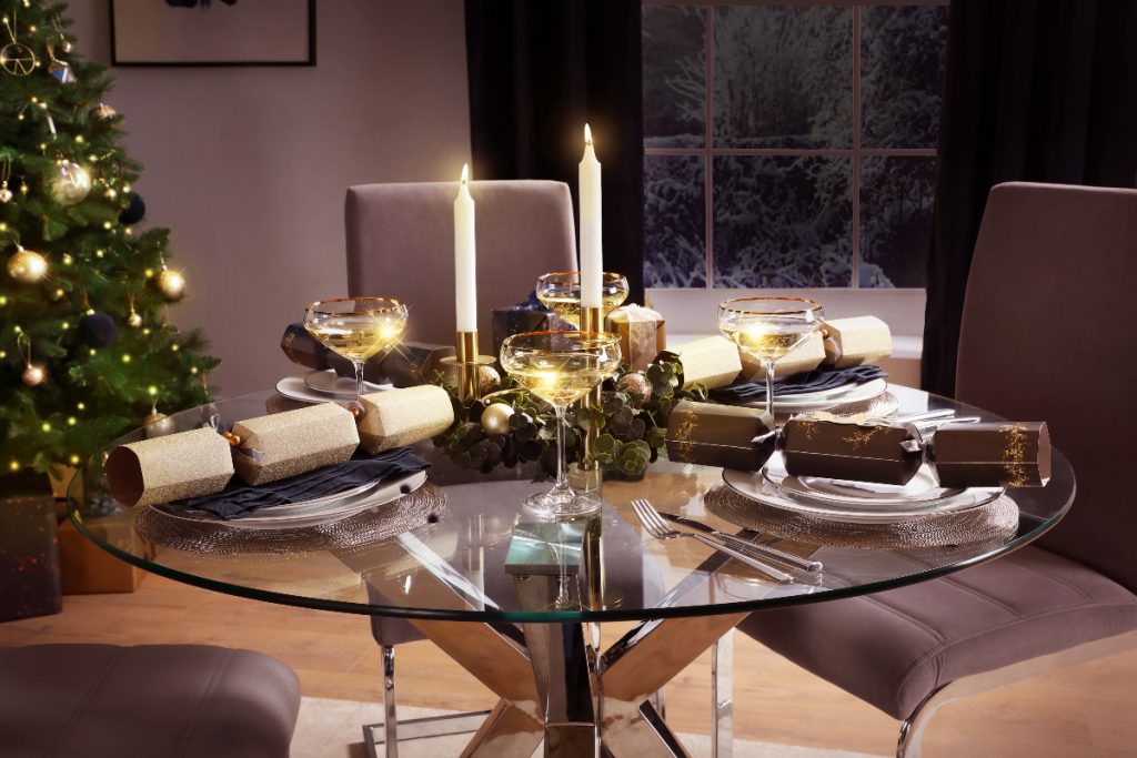 Dining room with simple glass table and velvet chairs for the holidays