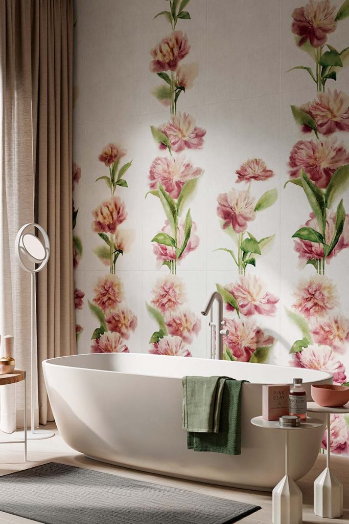 a maximalist bathroom featuring a modern freestanding bath and bold pink floral wall tiles