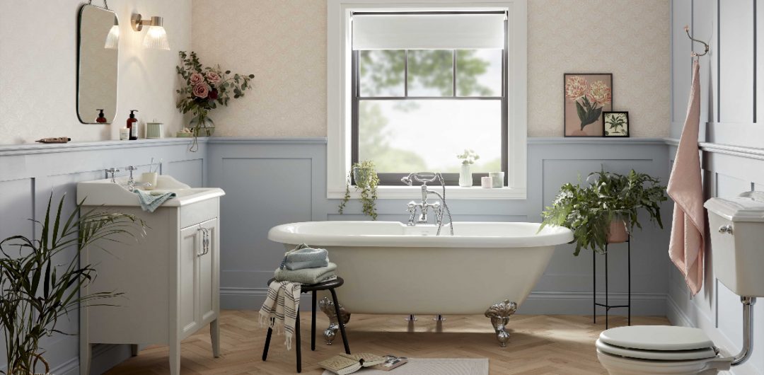 a modern rustic bathroom featuring a white roll top bath with silver claw feet