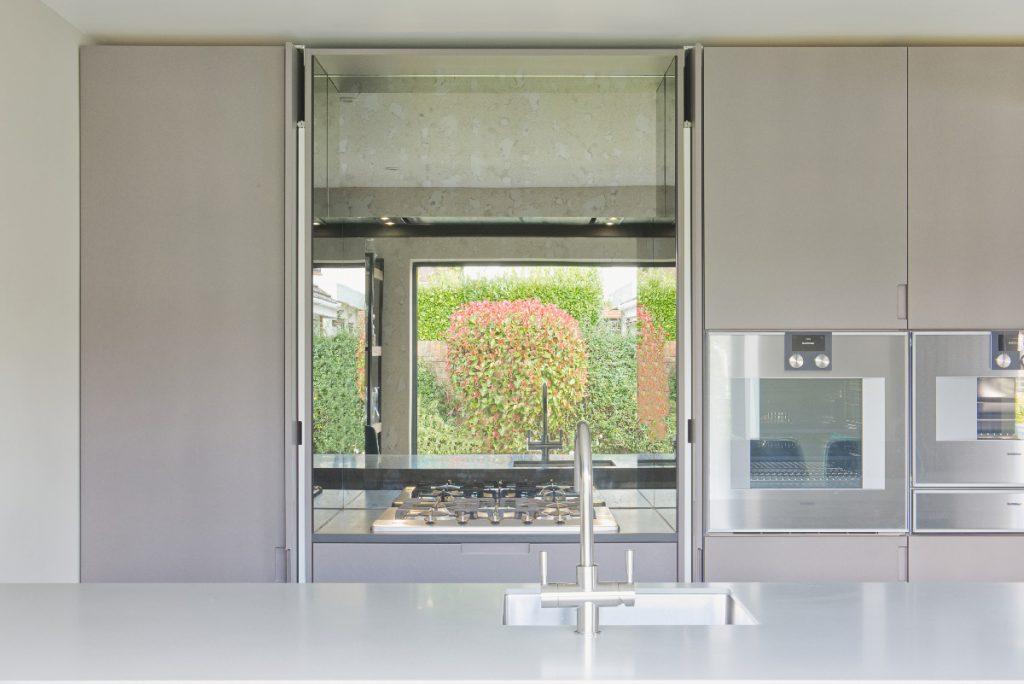 a design in a light grey palette with two ovens and grey cabinetry