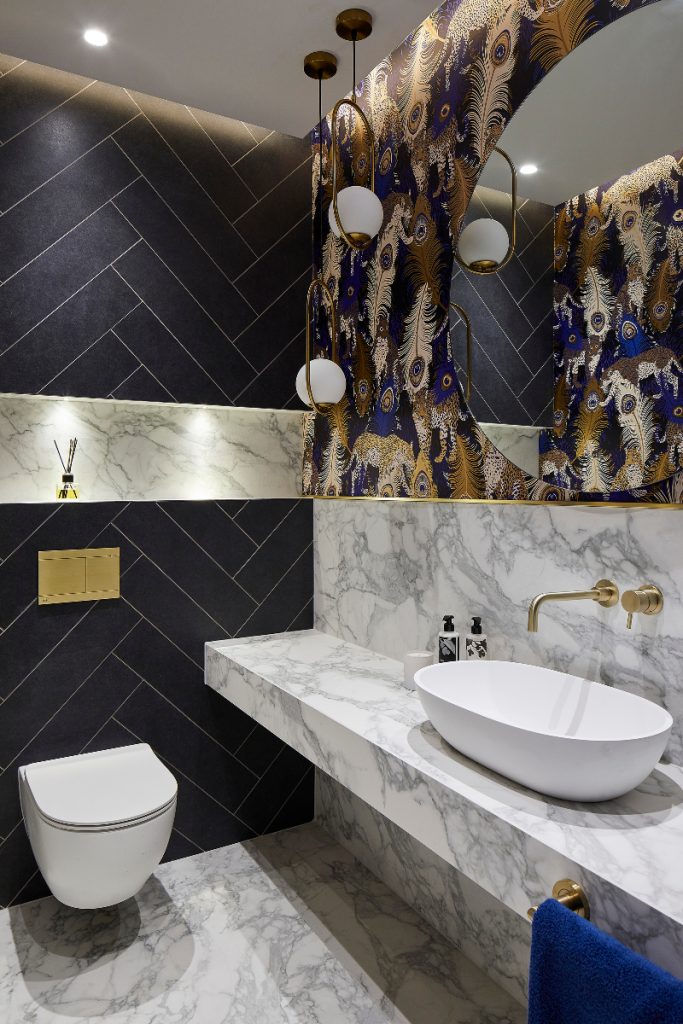 Coliseum Arabascato honed tiles around a white basin and toilet 