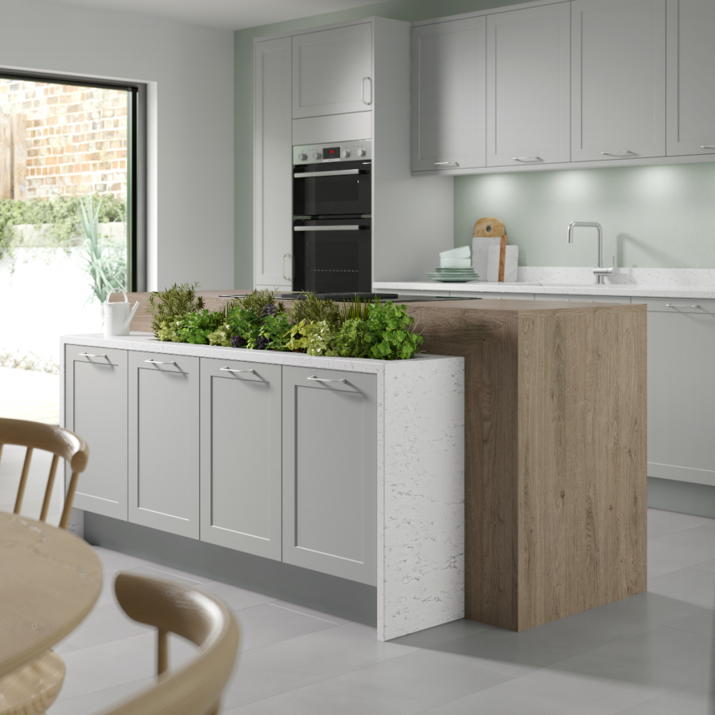 a kitchen herb garden in a storage planter behind a wooden kitchen island