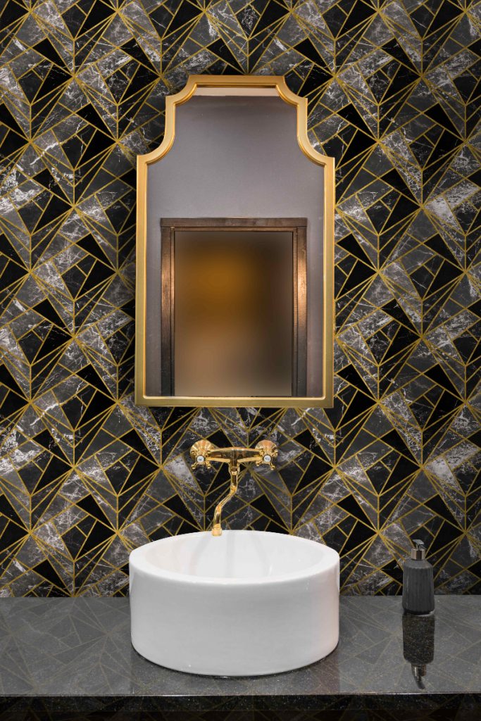 neo Onyx wallpaper in gold, black and white geometrical patterns with a rectangular wall mirror above a round white basin