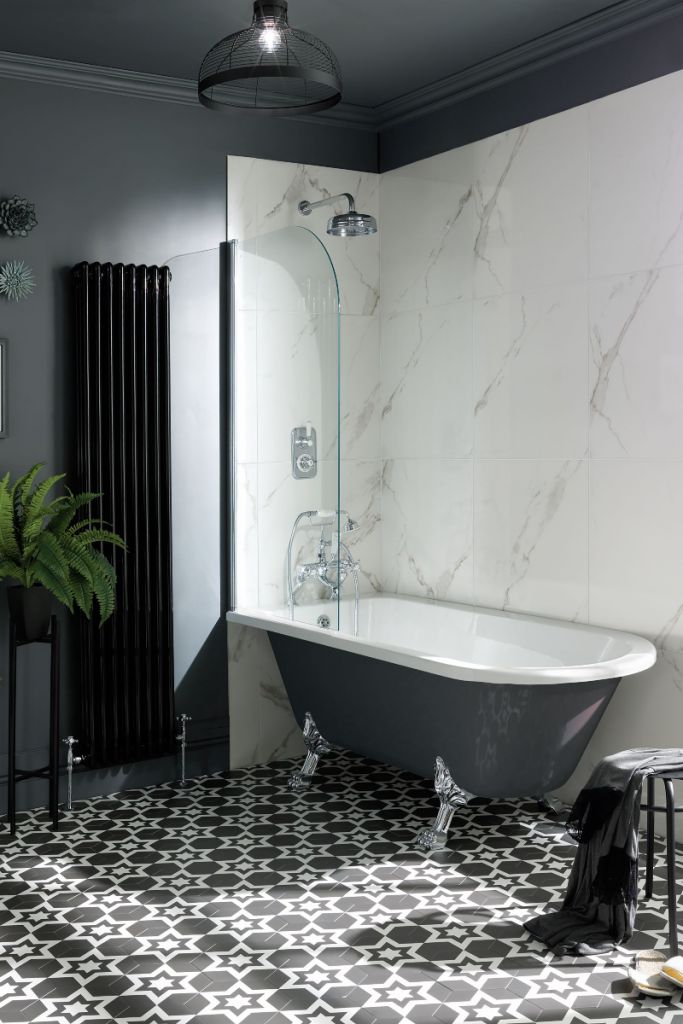 an anthracite freestanding roll top tub standing on monochrome floor tiles