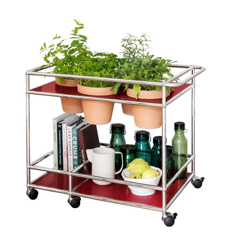 a kitchen herb garden in a silver serving trolley
