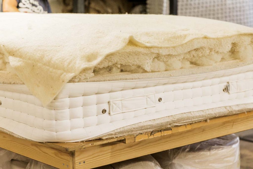 a comfy mattress with woollen blankets on top