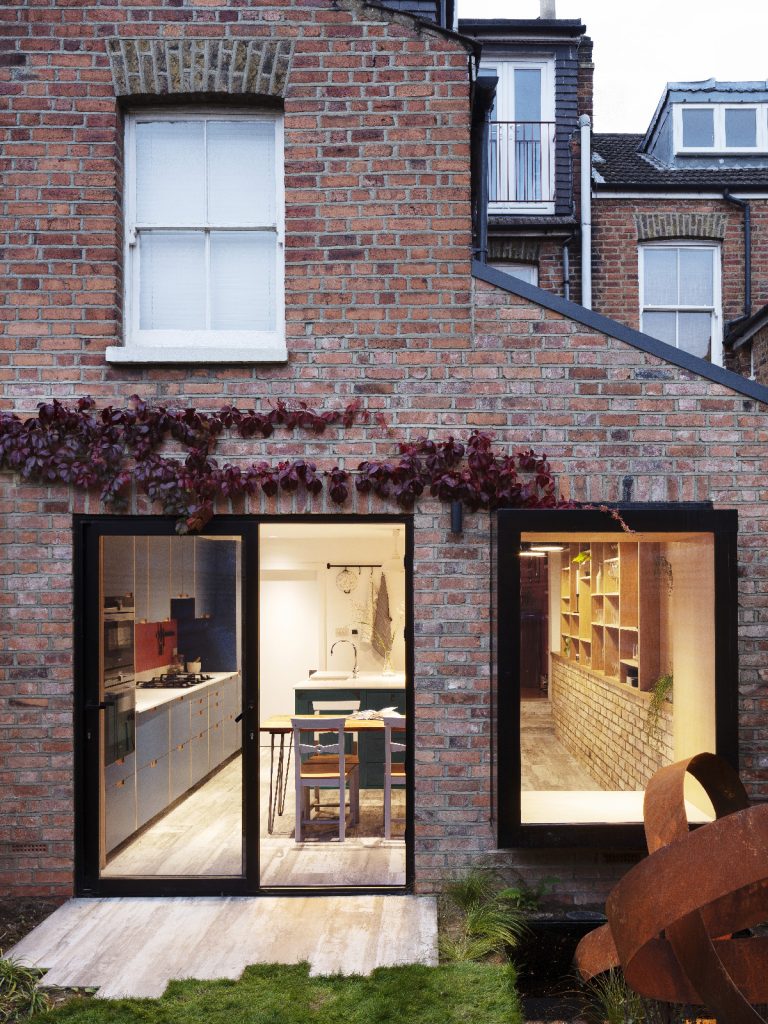 A build on a Victorian terraced house with a large window and bi-fold doors