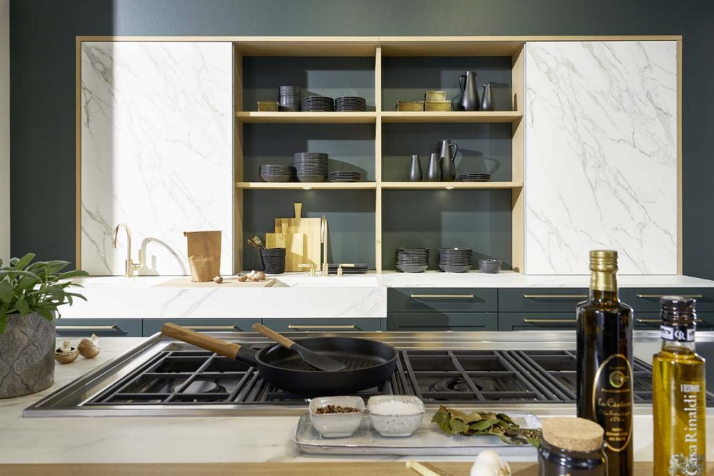 a Calacatta marble design with open shelving featuring black crockery and utensils