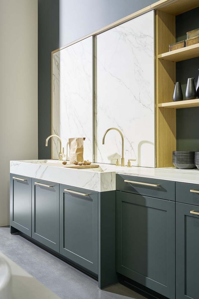 marble sliding doors and grey cabinetry with brass pull handles