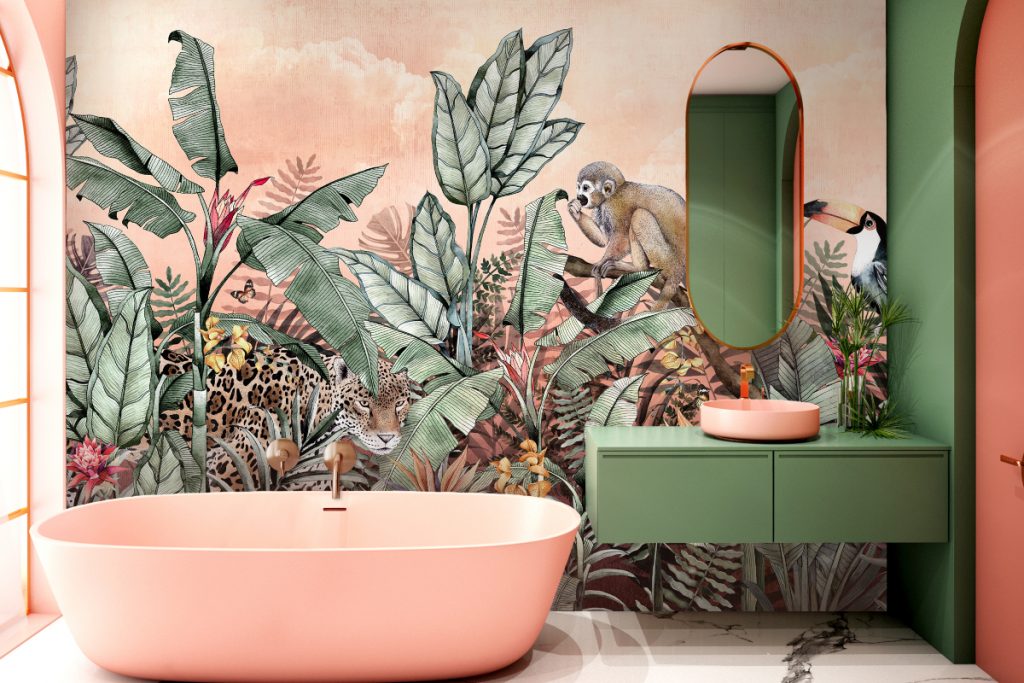 a tropical green and pink feature wall behind a pink freestanding bath and pink basin on green cabinetry