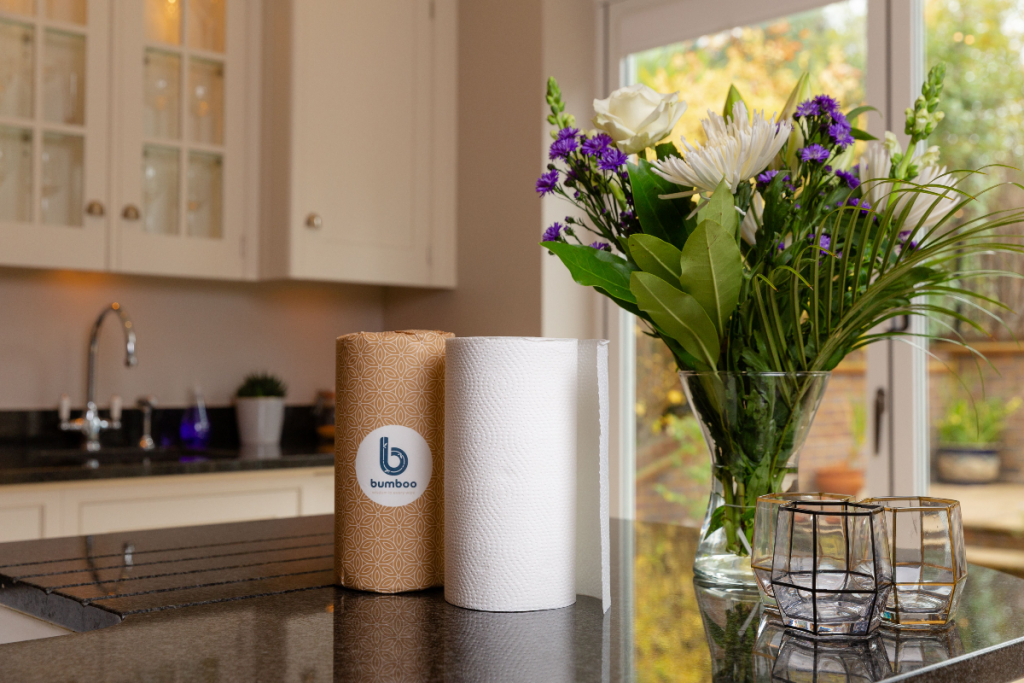 two rolls of kitchen towels on a kitchen worktop next to a big bunch of flowers