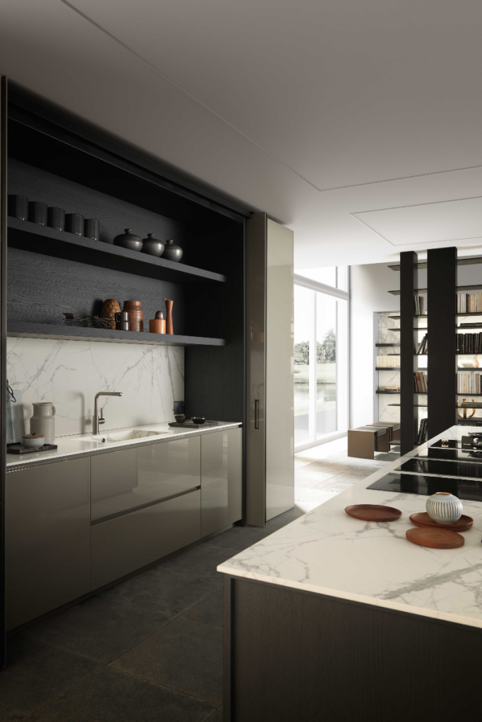 a kitchen layout with dark grey gloss handleless units and white marble worktops