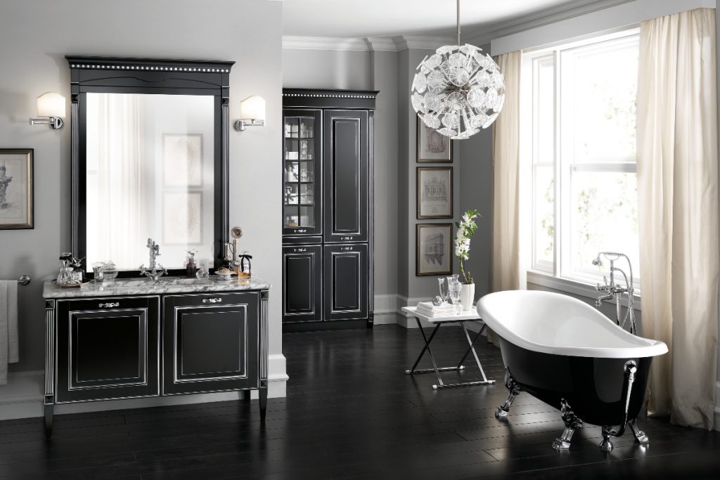 a traditional bathroom with a black roll top bath, dark shaker cabinetry, a pendant light and a large mirror