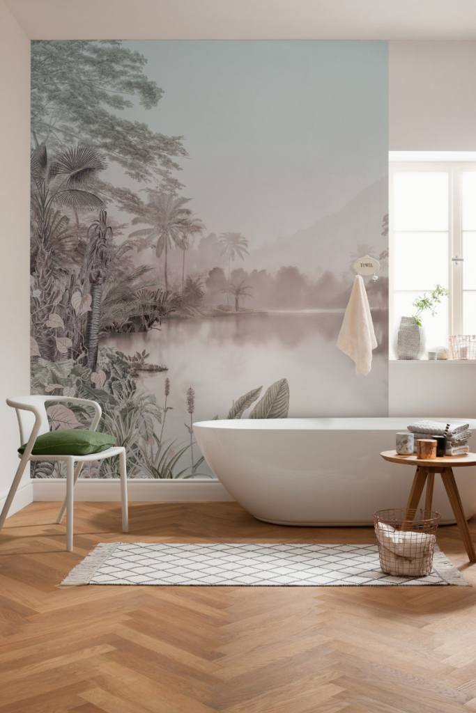 a tropical feature wall in muted colours behind a white freestanding bath