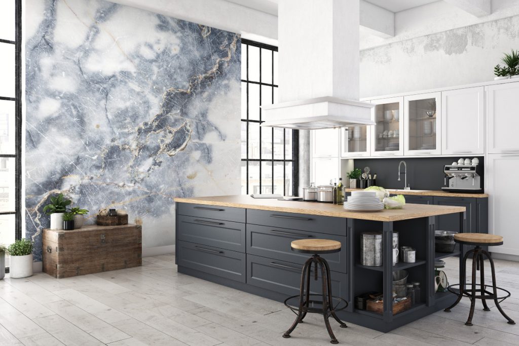 a white marble feature wall in front of an anthracite and wood kitchen