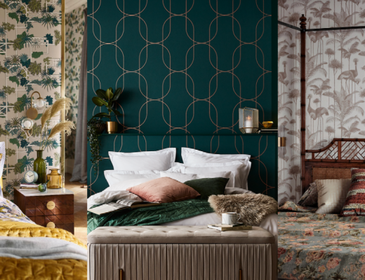 wallpaper for the bedroom featuring a green and gold geometric print behind a double bed