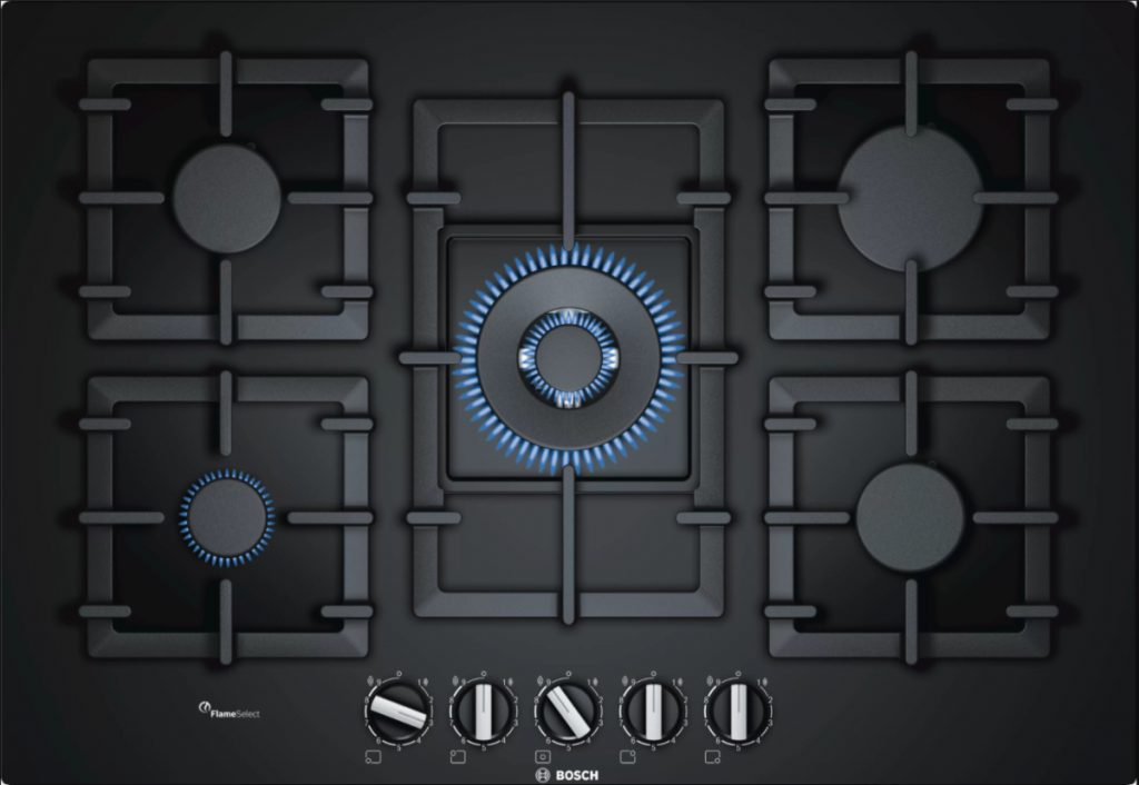 a black gas hob with a blue lit ring