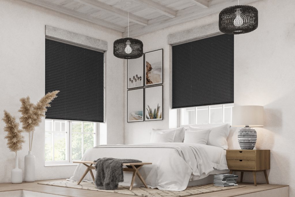 a guest bedroom with a white double bed, a wooden nightstand with a lamp on it, and black window blinds