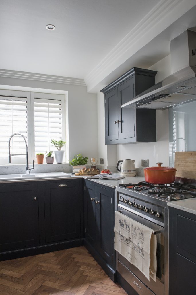 a blue shaker-style kitchen with traditional navy cabinetry