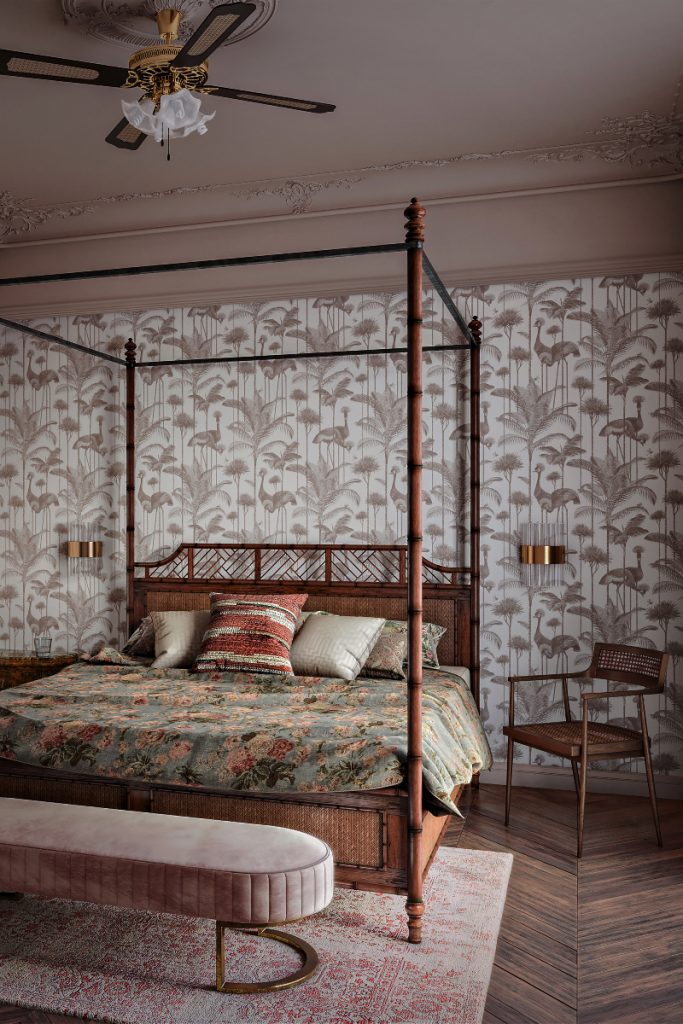 a floral print in beige and white featuring cranes and palm trees behind a four-poster bed with a green floral bedspread