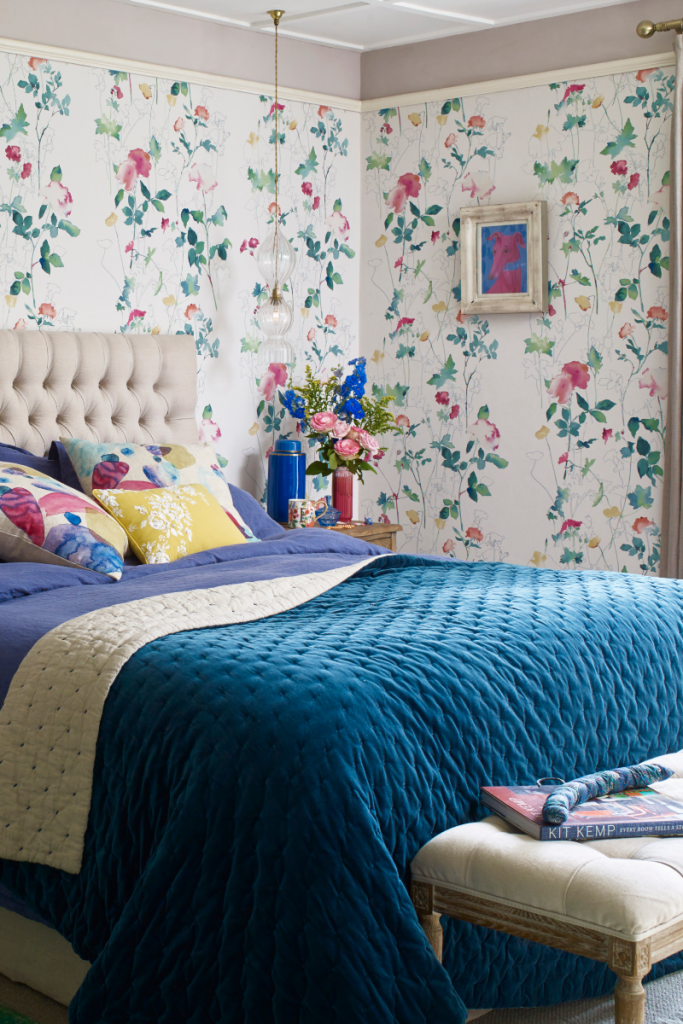 the Elizabeth Ockford floral Garden collection design next to a beige Chesterfield bed