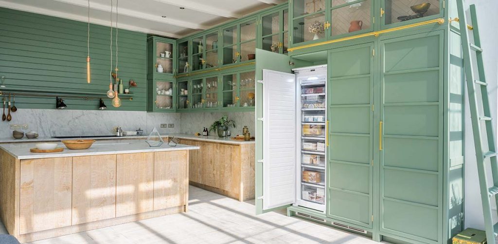 green cabinetry featuring built-in appliances in a large kitchen with a wooden and White Island