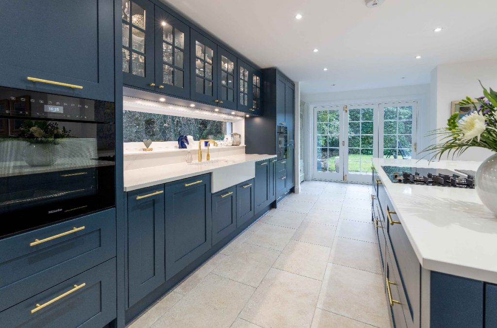 JS Geddes brass handles on navy cabinetry in a large room with white windows