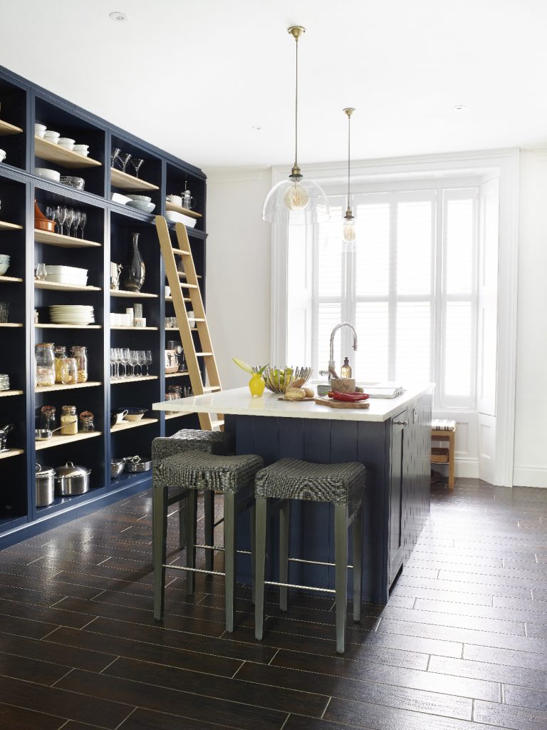 a blue shaker-style kitchen with navy cabinetry