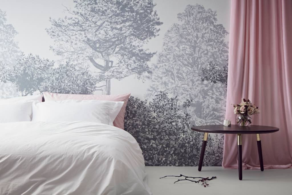 the latest wallpaper from Sian Zeng in a grey and white floral pattern behind a pink curtain and white bed