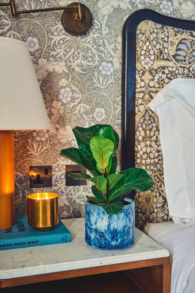 a fractured blue pot on a nightstand